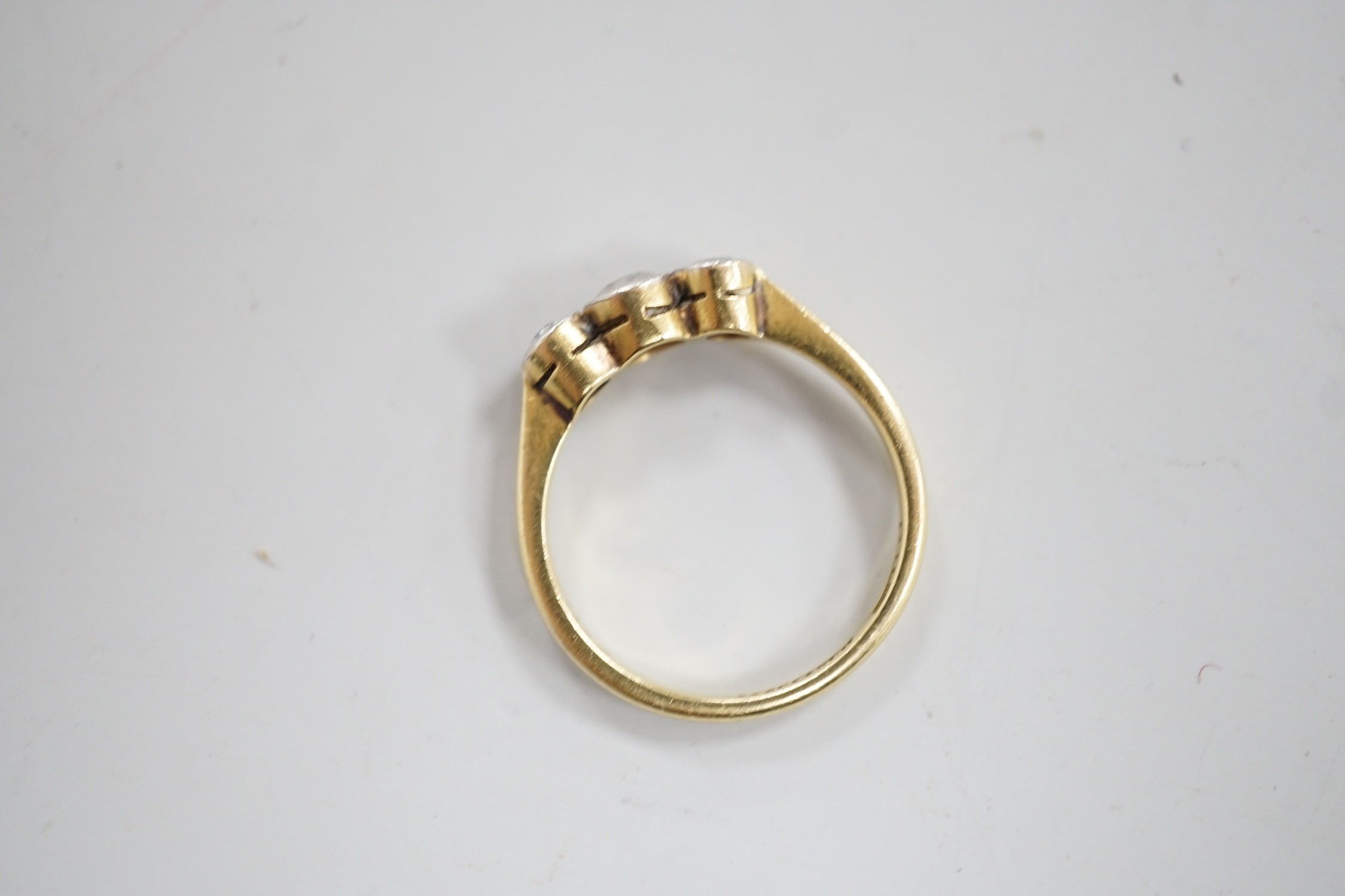 A mid 20th century 18ct, plat and three stone collet set diamond ring, size M, gross weight 2.5 grams.